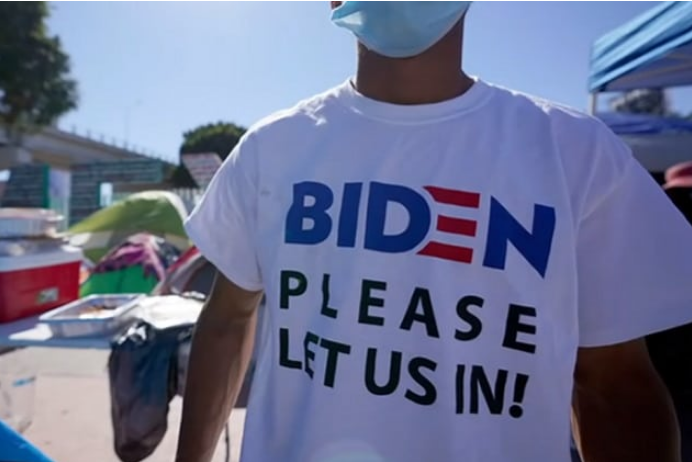 Who Is Supplying Migrants At The Border With Professionally Made Biden Signs And T-Shirts?
